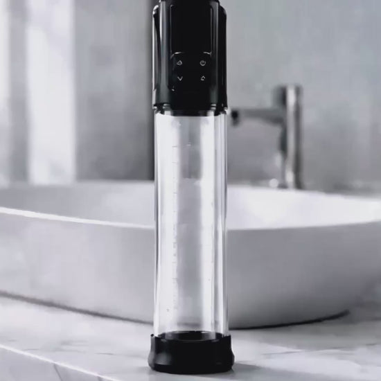 Erojoy Vacumate Automatic penis pump standing on a bathroom counter